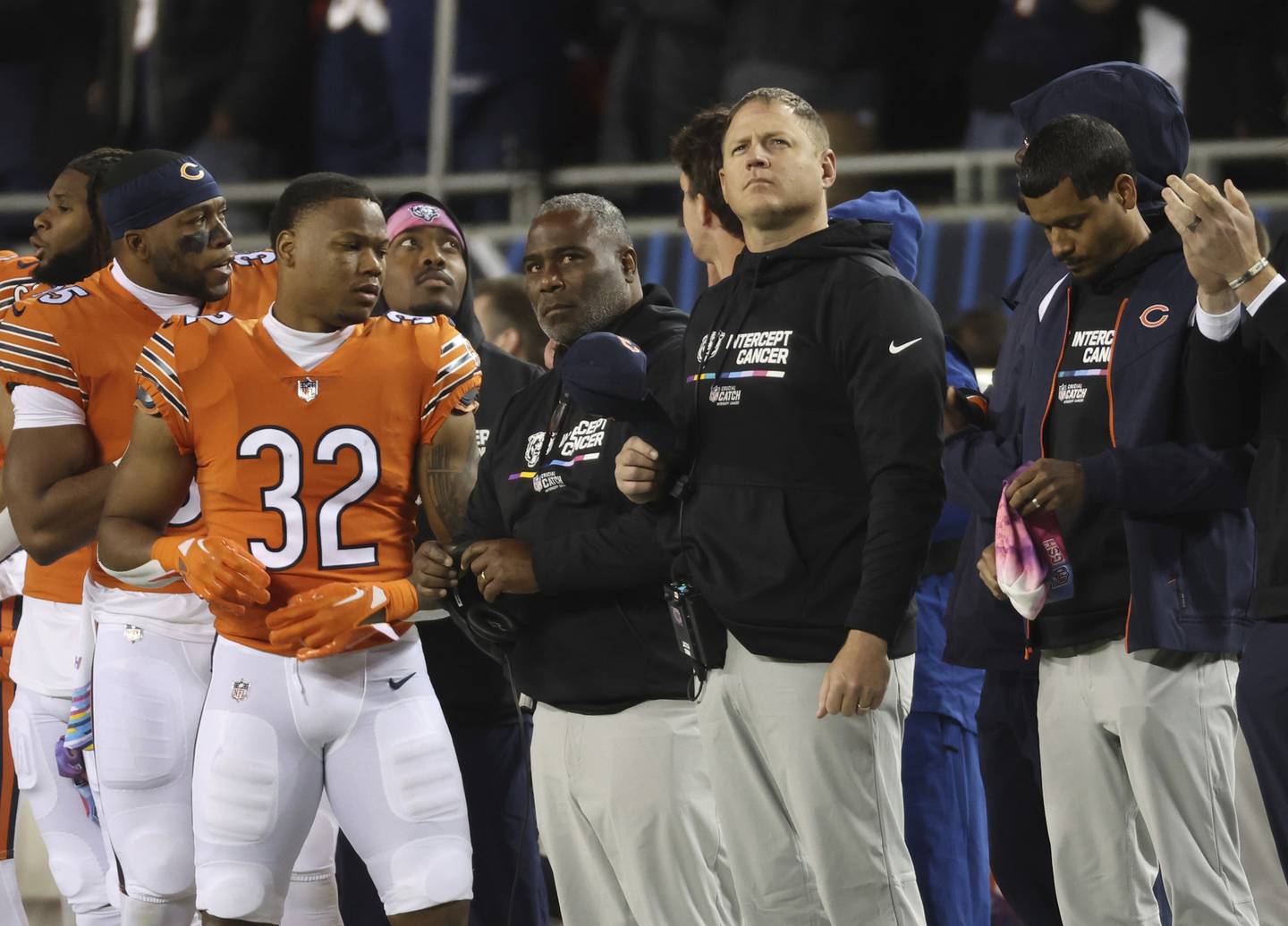Bears running backs coach David Walker, center left, and offensive coordinator Luke Getsy, center right, stand for the national anthem before a game against the Commanders on Oct. 13, 2022, at Soldier Field. 
