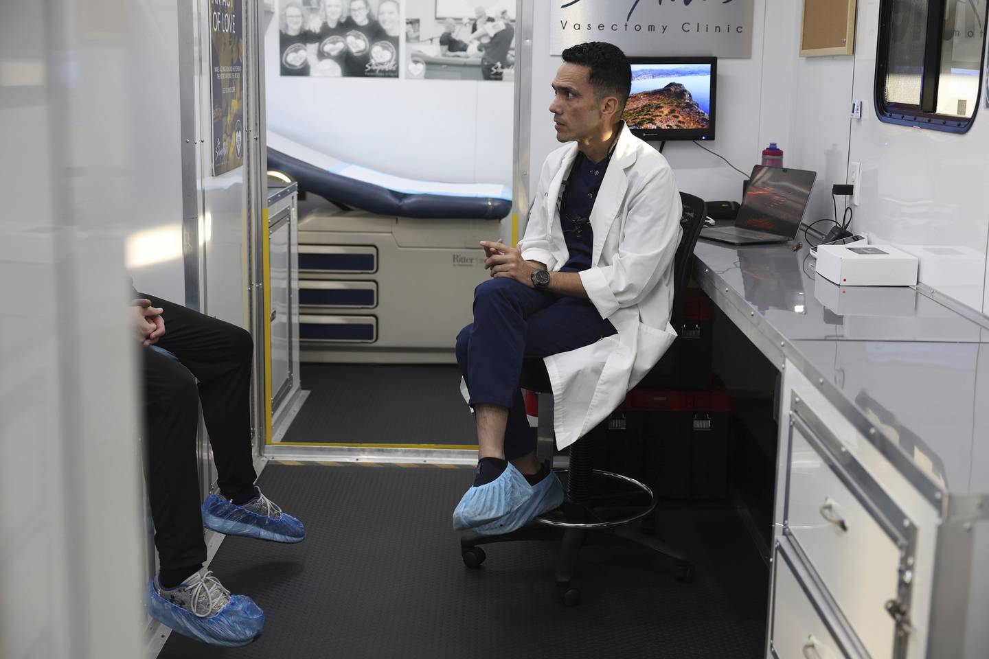 Dr. Esgar Guarín consults with a patient named Michael, last name not given, before performing a vasectomy in his mobile medical clinic on Oct. 29, 2022.