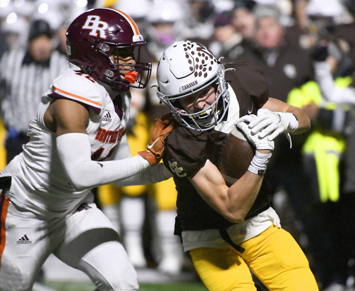 Mount Carmel's Jimmy Deacy, right, gets pushed out of bounds by Brother Rice's Sidney Green after making a catch during a Class 7A state quarterfinal game in Chicago on Saturday, Nov. 12, 2022.