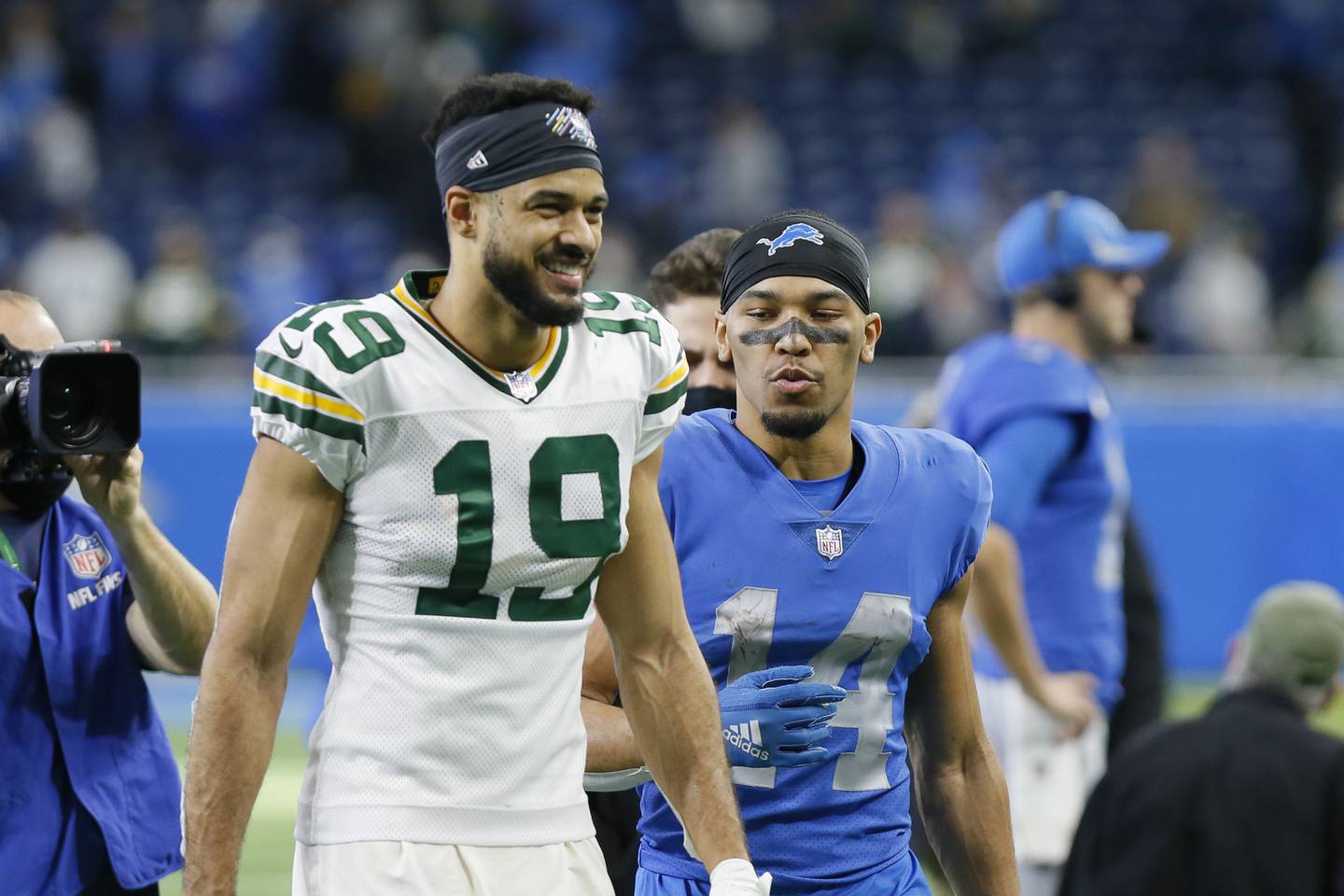 Packers wide receiver Equanimeous St. Brown (19) and Lions wide receiver Amon-Ra St. Brown walk off the field on  Jan. 9, 2022, in Detroit. 