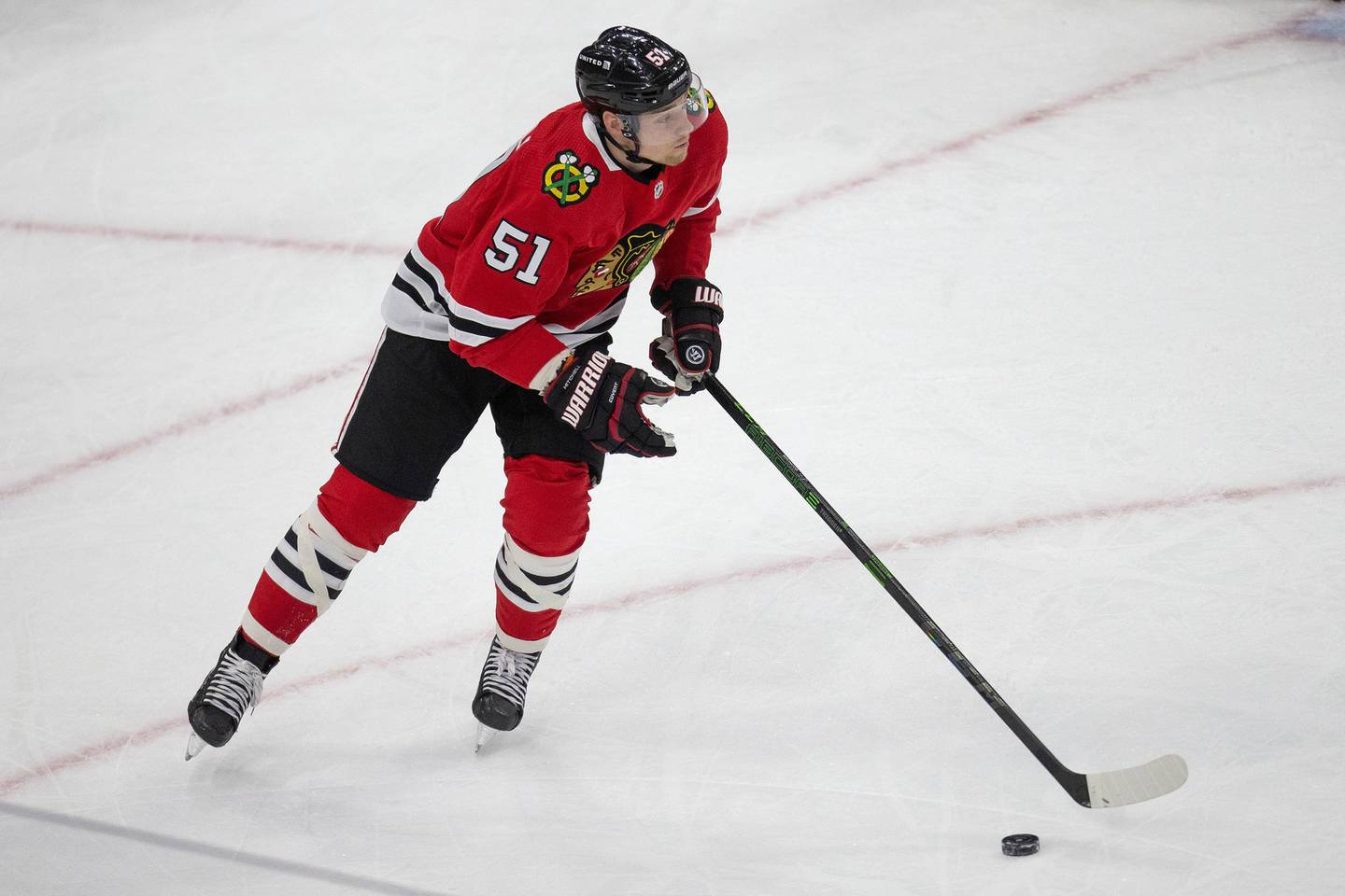 Chicago Blackhawks defenseman Ian Mitchell handles the puck during the second period against the Tampa Bay Lightning, March 7, 2021, at the United Center.