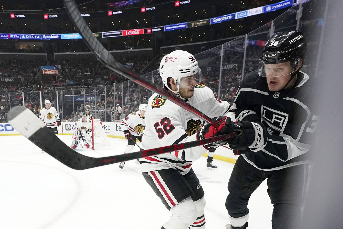 Chicago Blackhawks center Reese Johnson, left, and Los Angeles Kings right wing Arthur Kaliyev battle during the second period, Nov. 10, 2022, in Los Angeles.