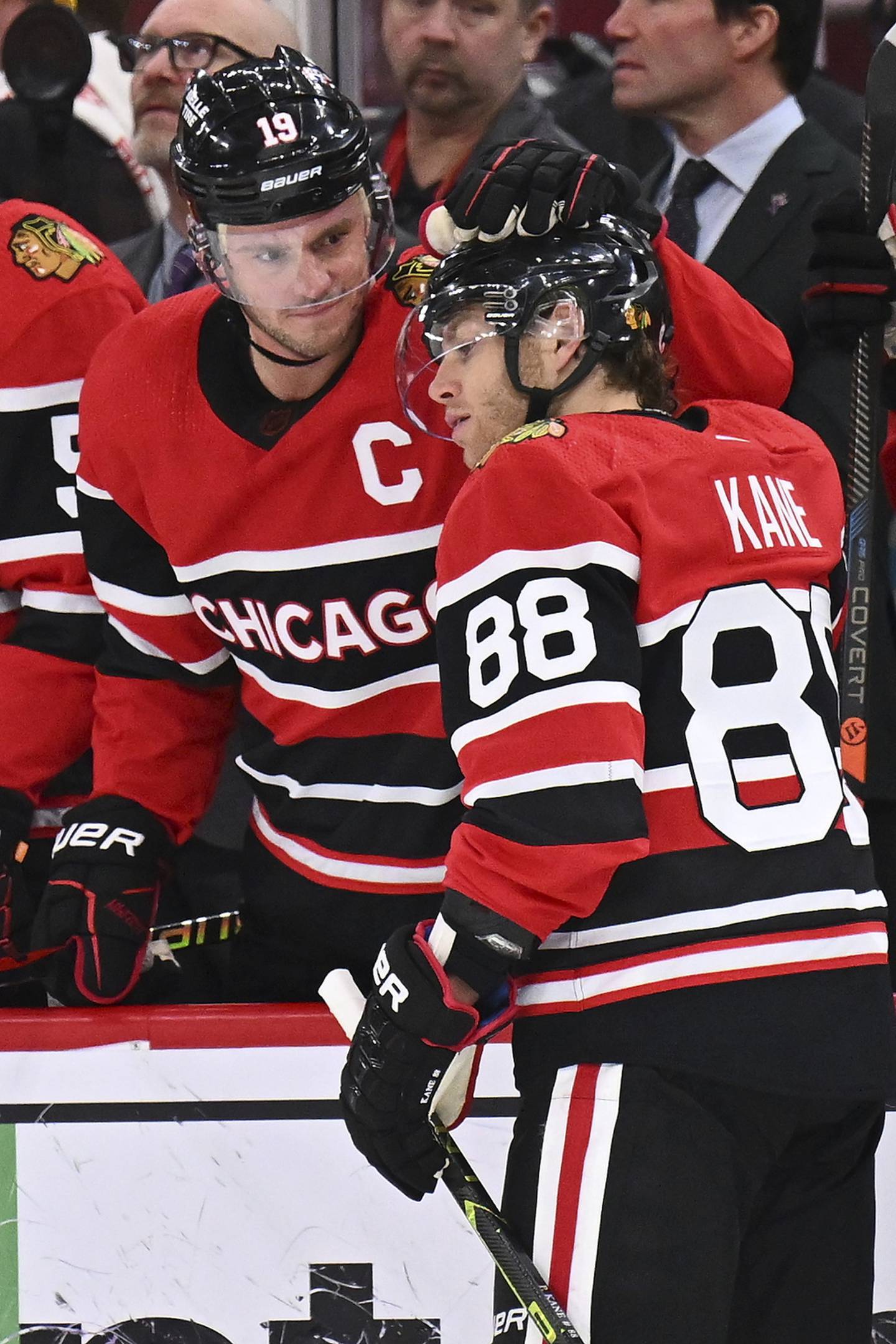 Jonathan Toews and Patrick Kane congratulate each other after being honored for playing their 1000th game together as teammates on Dec. 18, 2022 at United Center.