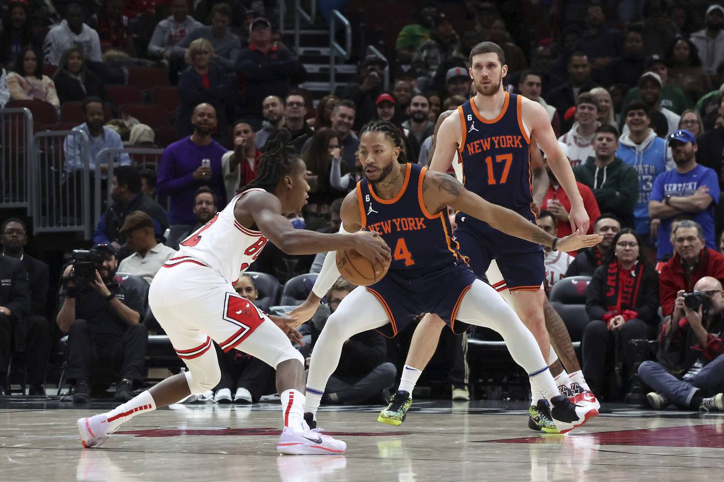 Bulls guard Ayo Dosunmu (12) is defended by Knicks guard Derrick Rose in the second half on Dec. 16 at the United Center.