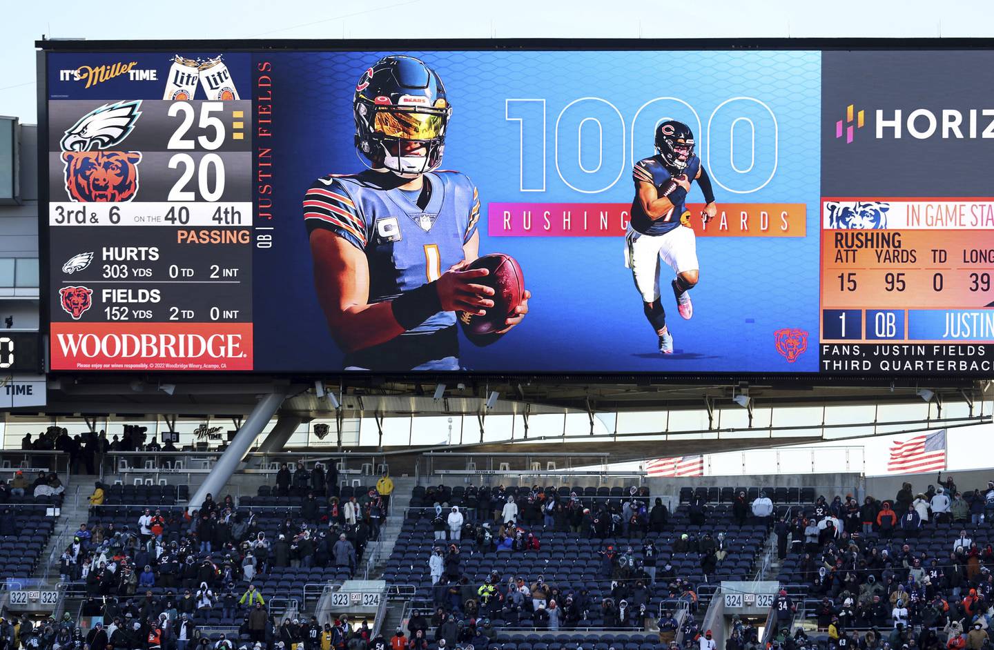 The video board at Soldier Field announces that Bears quarterback Justin Fields has reached 1,000 rushing yards this season on Dec. 18, 2022.