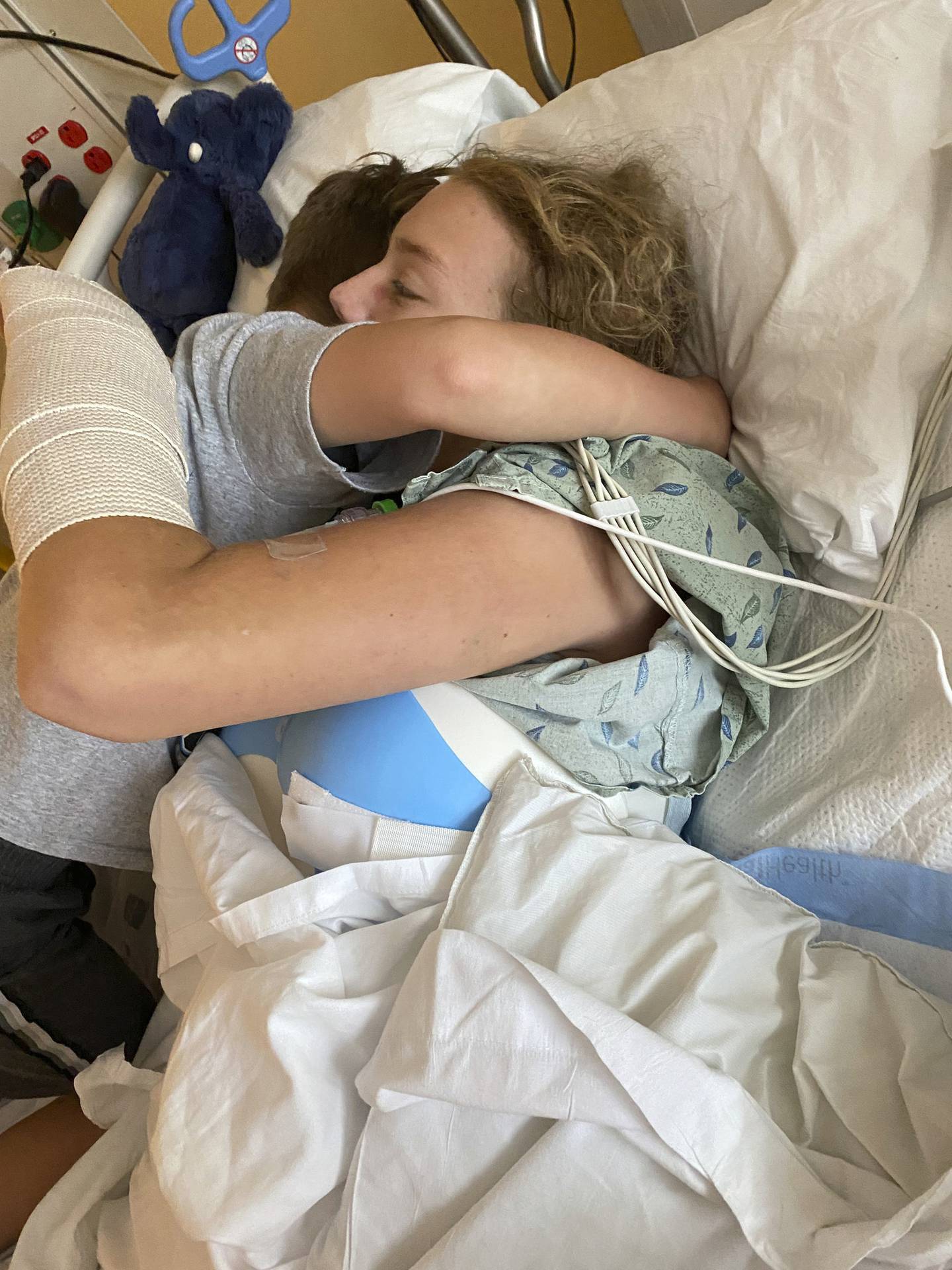 Silas Mitchell hugs his sister Jasper Fidler for the first time in the ICU after Jasper was hospitalized from a rock climbing accident. Silas and Jasper wrote a song together for the Sing Me a Story project. 