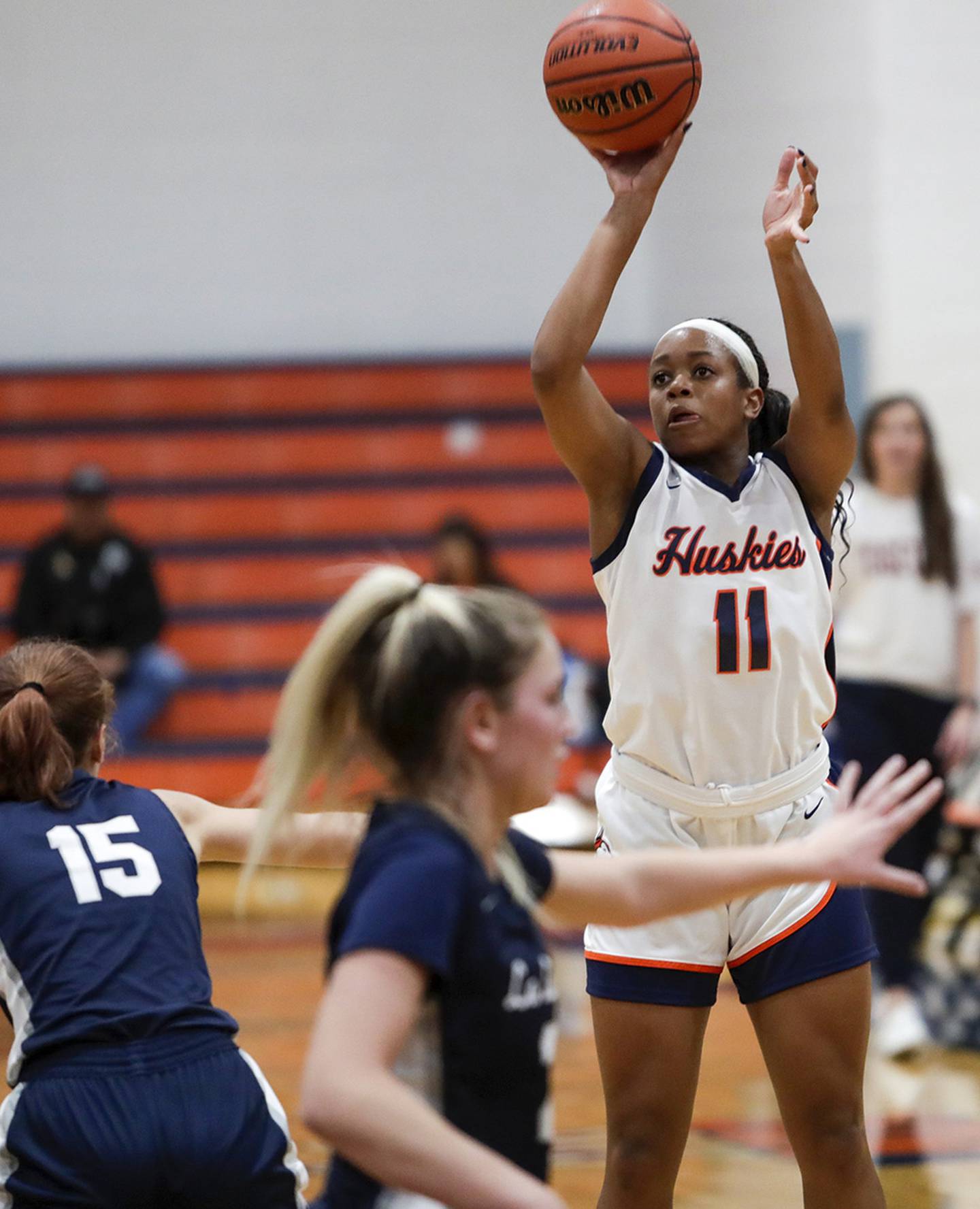Naperville North’s Layla Henderson (11) puts up a shot against La Lumiere’s Lila Sirko (15) during a game in Naperville on Tuesday, Dec. 6, 2022.