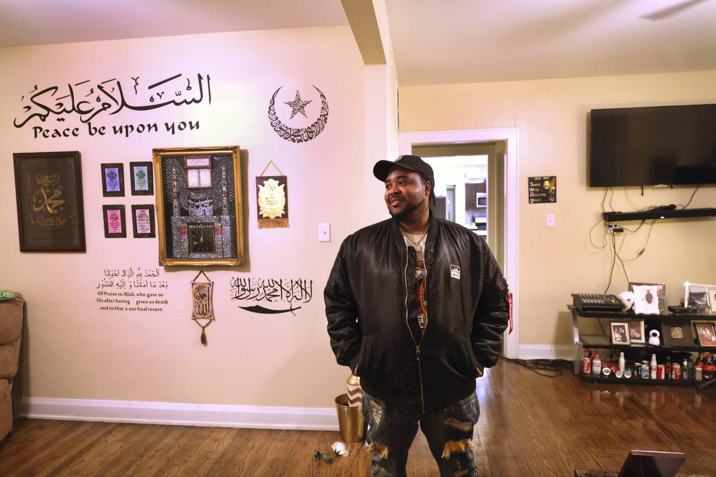 Taqi Thomas, IMAN's community engagement and safety senior manager, stands in his bungalow in the Chicago Lawn neighborhood on Dec. 1, 2022. 
