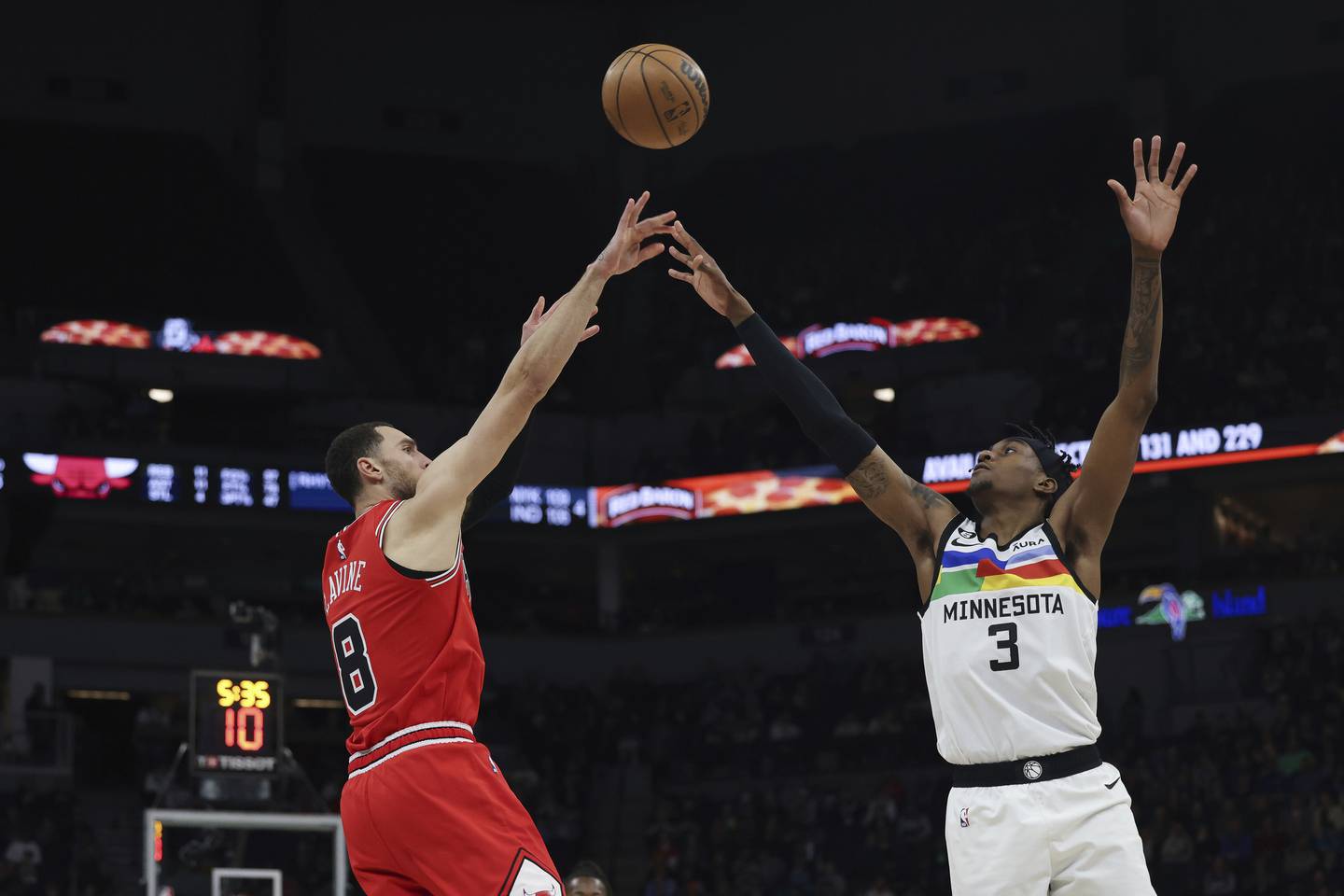 Bulls guard Zach LaVine shoots over Timberwolves forward Jaden McDaniels during the first half on Dec. 18, 2022.