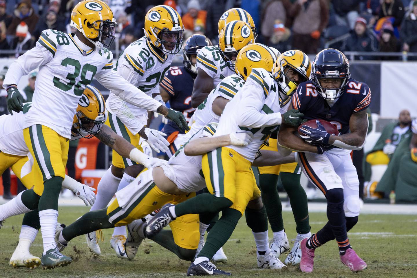 Bears wide receiver Velus Jones Jr. (12) is tackled by a pack of Packers during the fourth quarter Dec. 4, 2022, at Soldier Field.