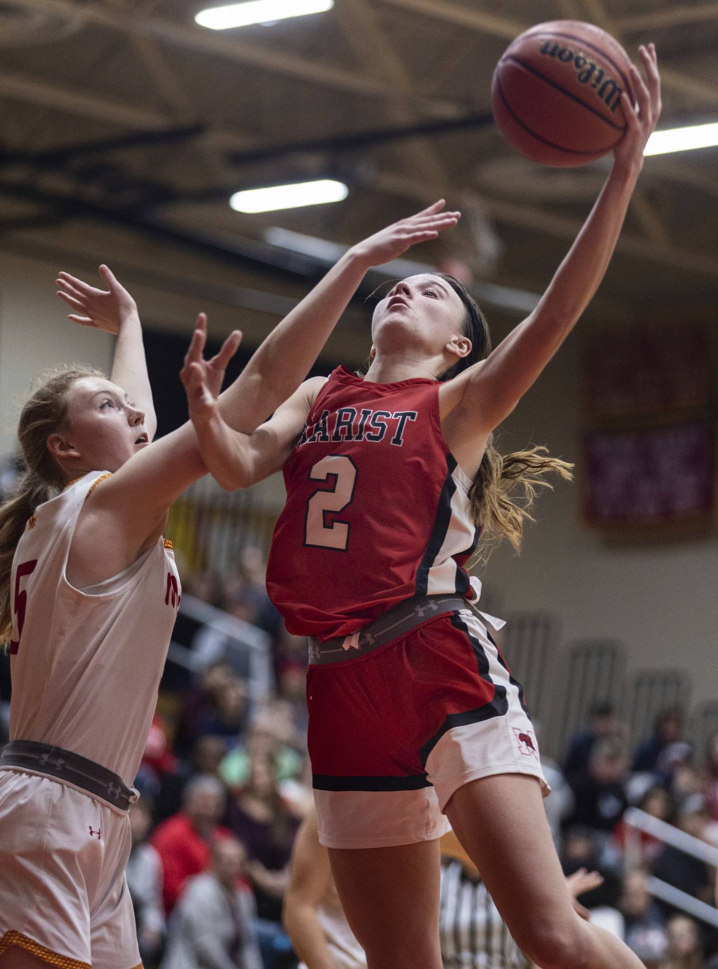 Marist’s Elise Ward (2) works a hook shot over Mother McAuley's Morgan Feil (5) in overtime of a nonconference game in Chicago on Thursday, Dec. 8, 2022.