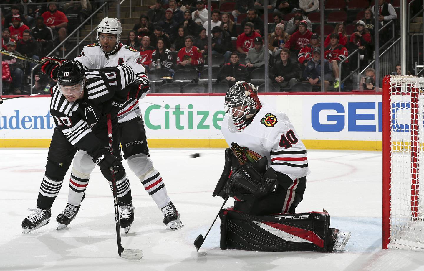 Goaltender Arvid Soderblom stops a shot on goal as the Devils' Alexander Holtz and Seth Jones battle for position during the second period on Dec. 6, 2022.