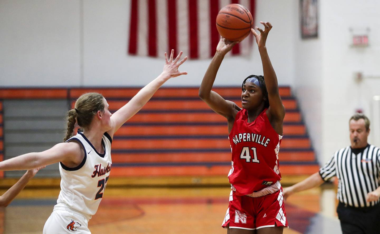 Naperville Central’s Trinity Jones (41) puts up a 3-point shot against Naperville North’s Peyton Fenner (23) during a DuPage Valley Conference game in Naperville on Wednesday, Dec. 14, 2022. 
