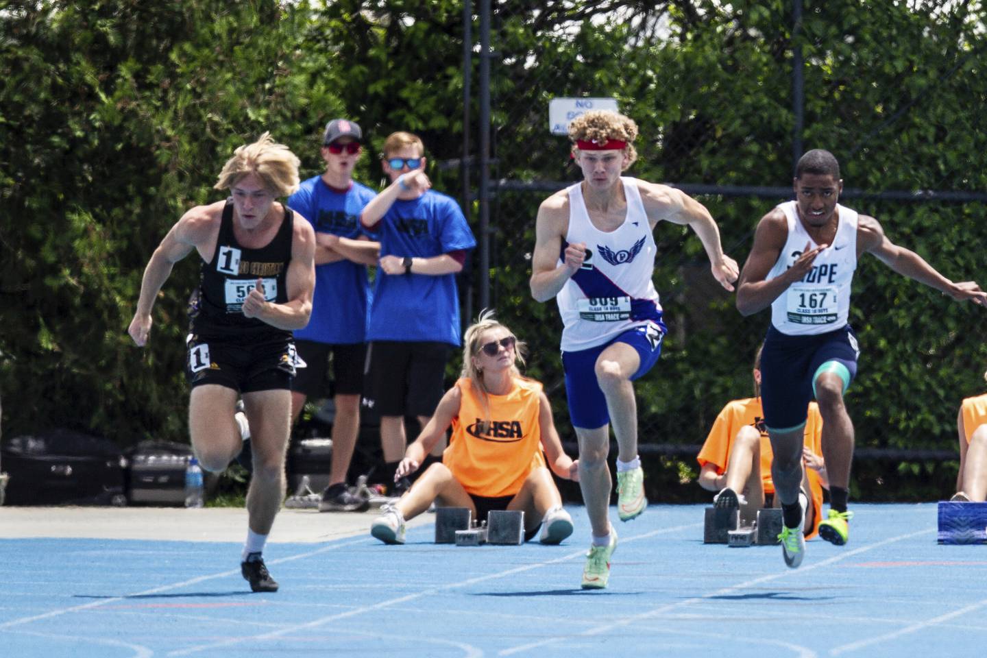 Chicago Christian's Luke Jelderks, left, bolts out of the blocks in the 100-meter dash in the Class 1A boys track state finals at Eastern Illinois University's O'Brien Stadium in Charleston on Saturday, May 28, 2022.
