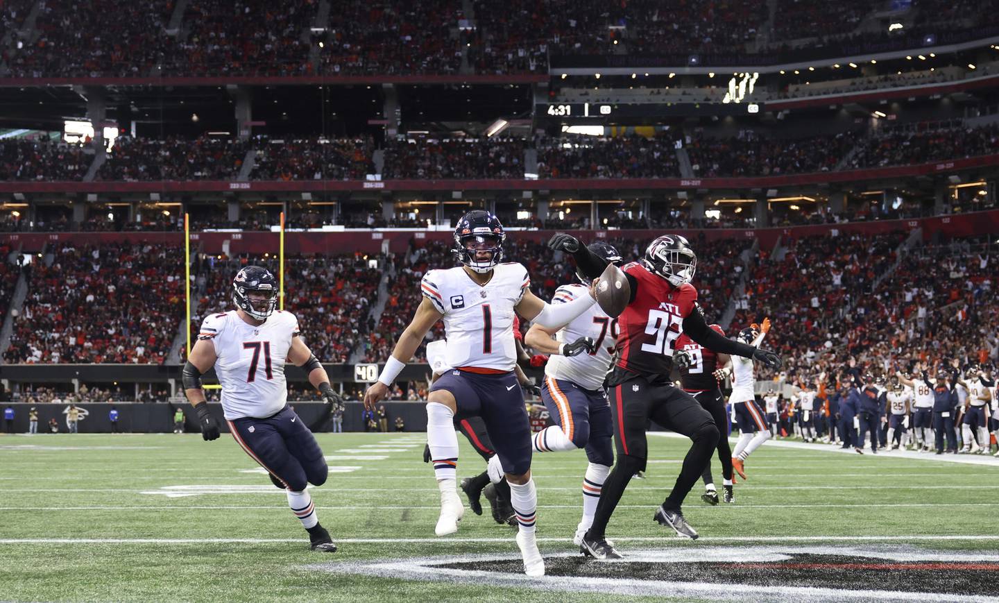 Bears quarterback Justin Fields keeps the ball for a rushing touchdown in the second quarter against the Falcons at Mercedes-Benz Stadium on Nov. 20, 2022.