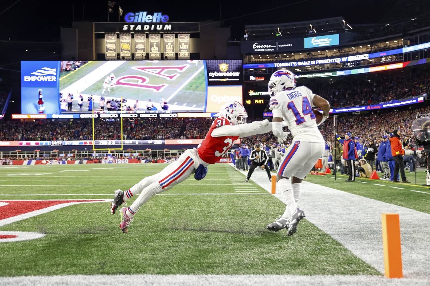 Bills wide receiver Stefon Diggs scores a touchdown while defended by Patriots cornerback Jonathan Jones during the first half on Dec. 1, 2022.