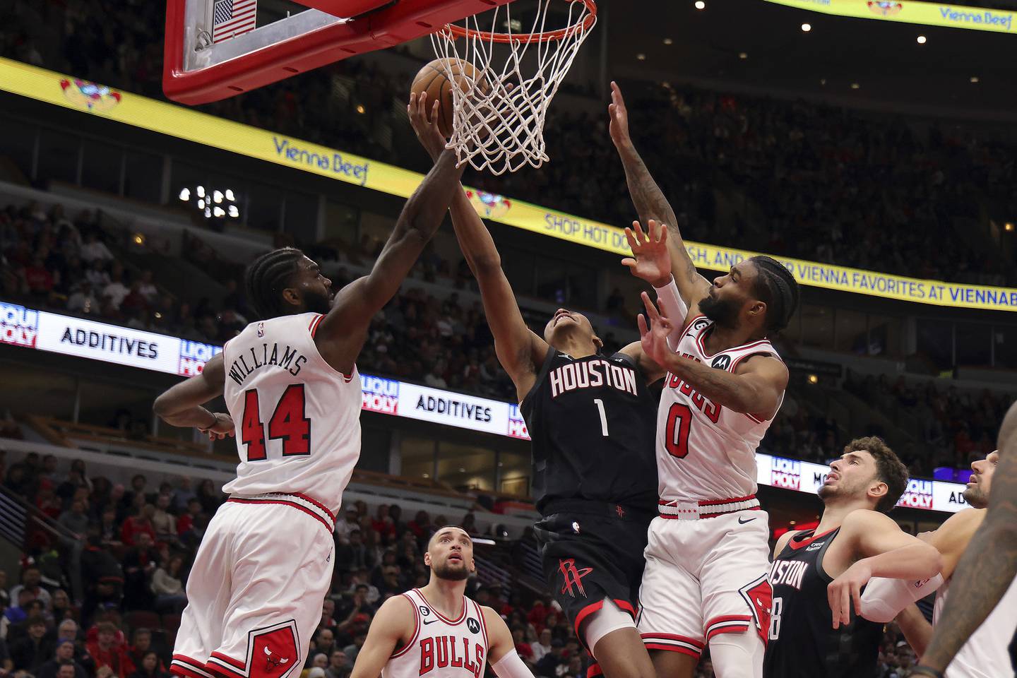 Rockets forward Jabari Smith Jr. (1) goes up for a shot as Bulls forward Patrick Williams (44) and guard Coby White (0) defend in the second half Monday, Dec. 26, 2022, at the United Center.