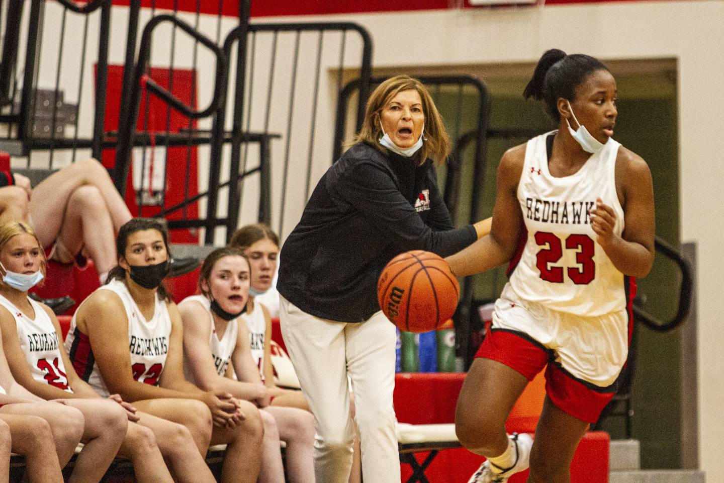 Marist's coach Mary Pat Connolly calls out a play as Le'lani Harris brings the ball up court during a game against Simeon on Monday, Nov. 22, 2021.