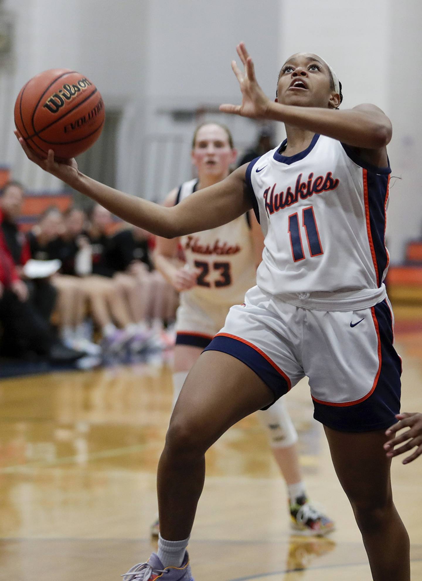 Naperville North’s Layla Henderson (11) goes for a layup against Naperville Central’s Trinity Jones (41) during a DuPage Valley Conference game in Naperville on Wednesday, Dec. 14, 2022.