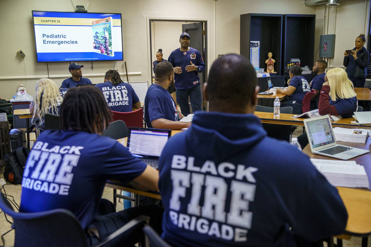 Chicago Fire Department Lt. Quention Curtis speaks with students at the Black Fire Brigade in the Washington Park neighborhood on April 7, 2022. 