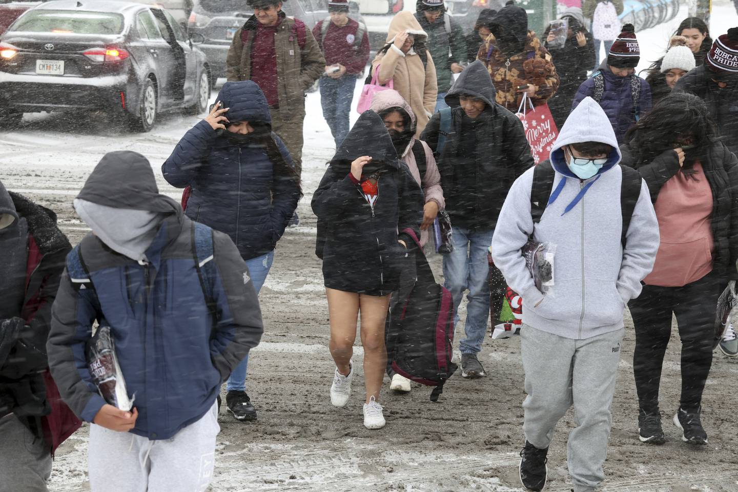 Students leave Back of the Yards College Preparatory High School at West 47th Street and Hoyne Avenue in Chicago at the end of the school day on Dec. 22, 2022. 