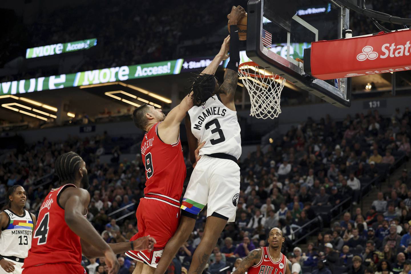 Timberwolves forward Jaden McDaniels goes up to the basket against Bulls center Nikola Vucevic during the second half on Dec. 18, 2022.