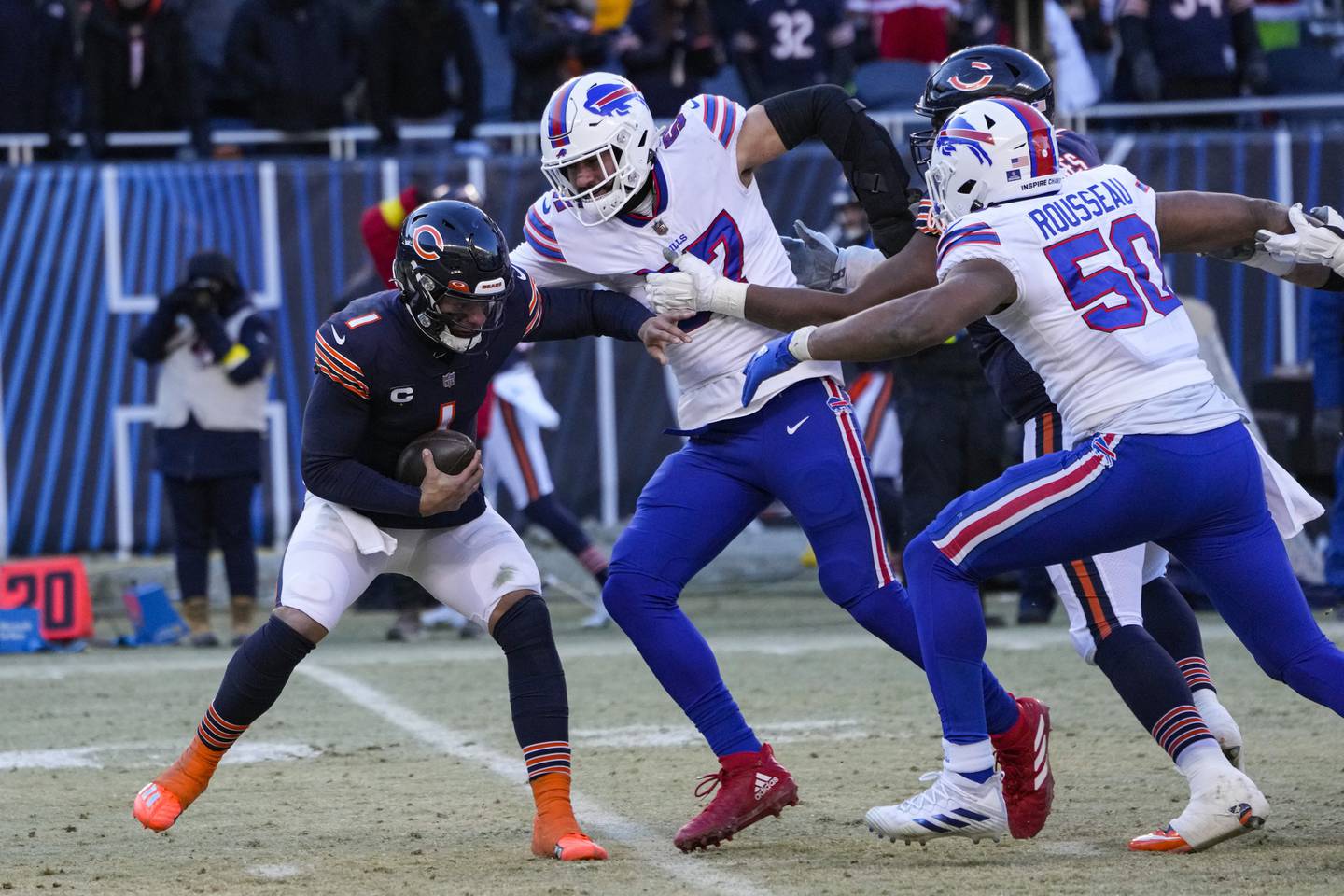 Chicago Bears quarterback Justin Fields (1) is sacked by Buffalo Bills defensive end A.J. Epenesa (57) in the second half of an NFL football game in Chicago, Saturday, Dec. 24, 2022. (AP Photo/Charles Rex Arbogast)