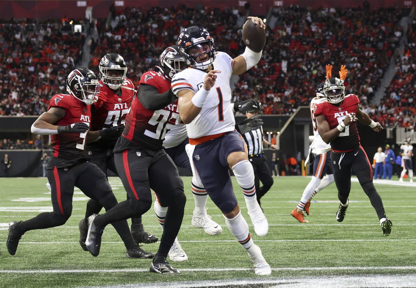 Bears quarterback Justin Fields (1) rushes for a touchdown against the Falcons on Nov. 20, 2022, in Atlanta.