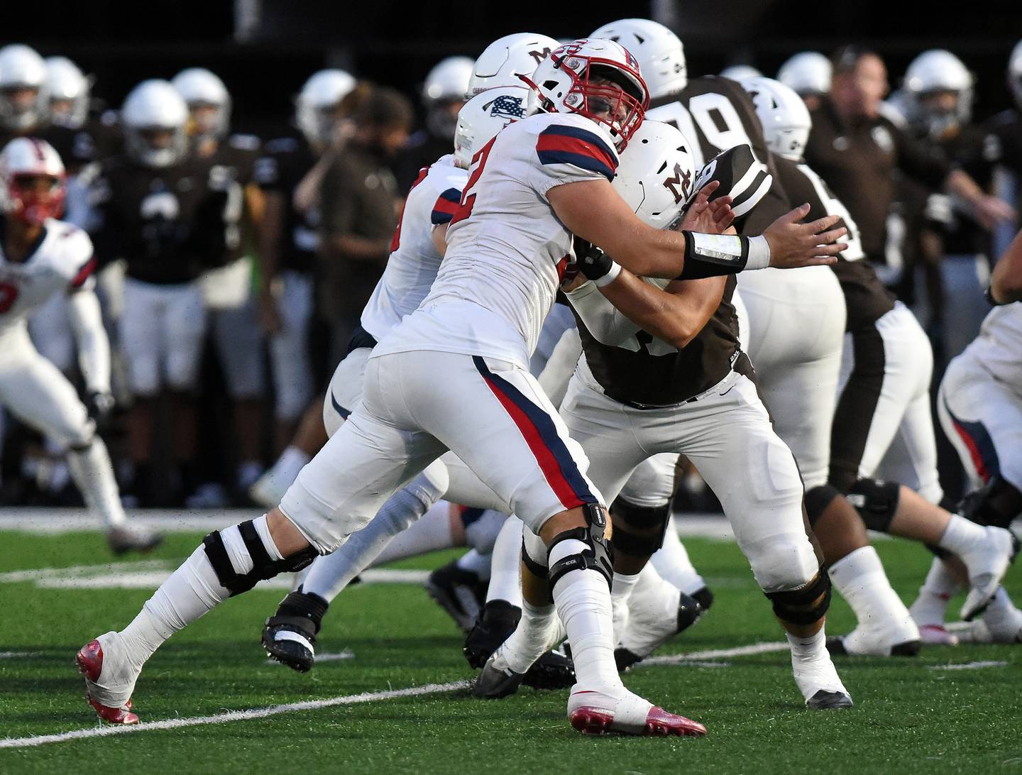 St. Rita's Patrick Farrell (52) tries to put pressure on Mount Carmel during the season opener in Chicago on Friday, August 26, 2022.