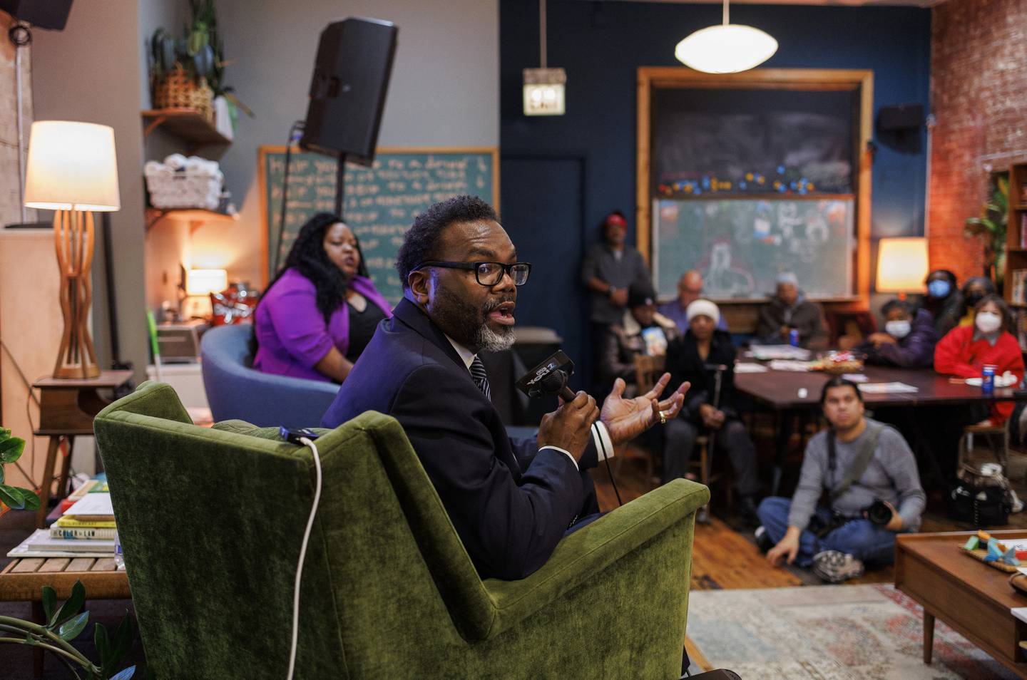 Mayoral candidate Brandon Johnson, a Cook County commissioner, speaks with attendees during a town hall at Principle Barbers in Chicago on Dec. 19. 