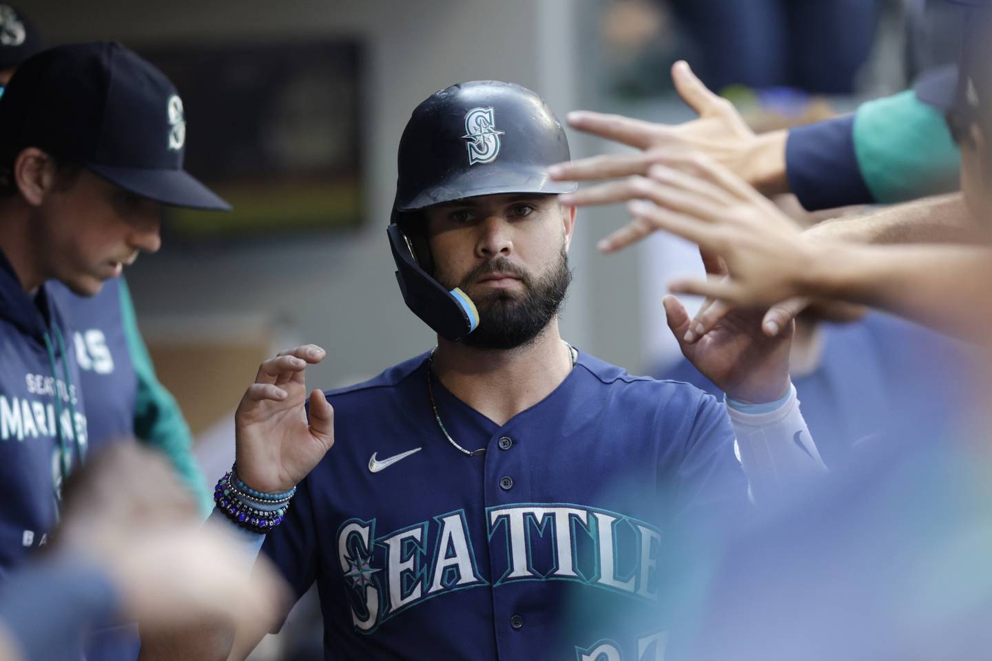 The Mariners' Jesse Winker is congratulated in the dugout after scoring against the Athletics during the eighth inning on Oct. 1, 2022.