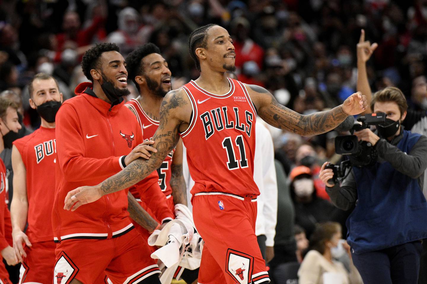 Bulls forward DeMar DeRozan celebrates with teammates after making a 3-pointer at the buzzer against the Wizards on Jan. 1 in Washington. The Bulls won 120-119.