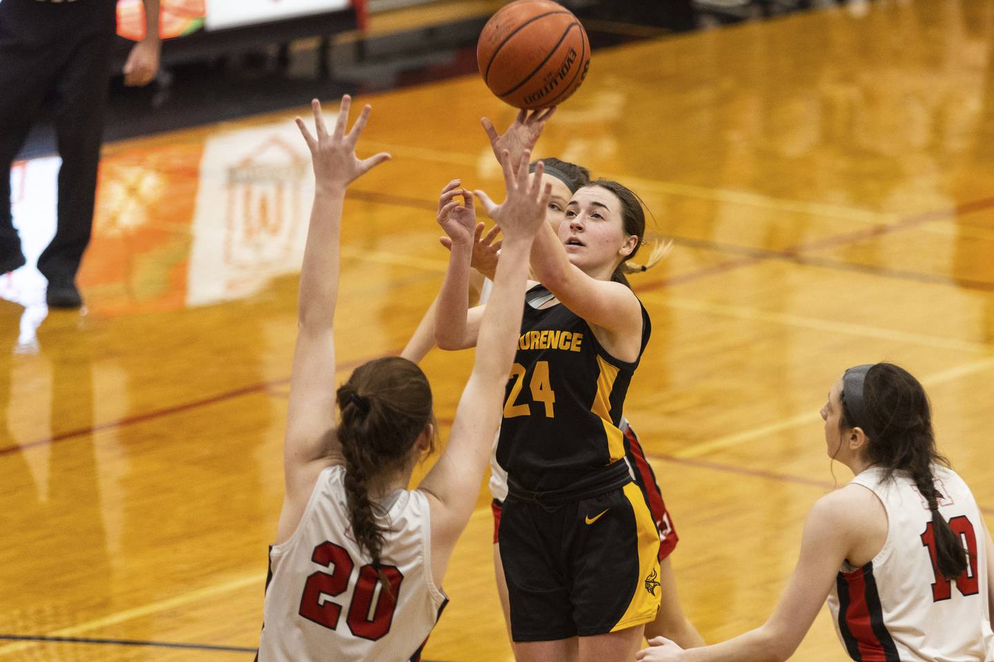 St. Laurence's Clare Allison (24) floats a shot over Marist’s Nora Brusek (20) during a nonconference game in Chicago on Monday, Dec. 19, 2022.