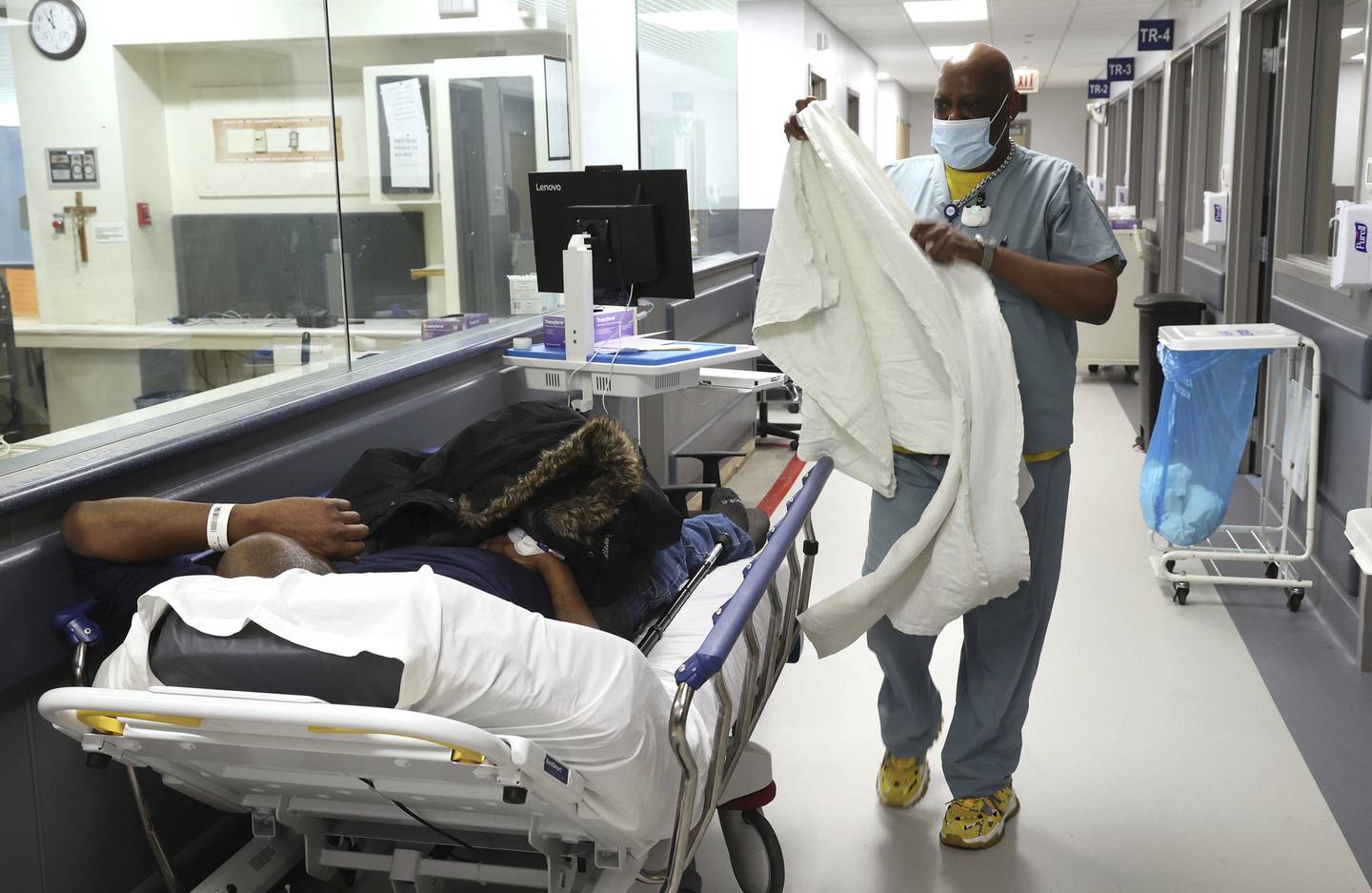 An employee brings a blanket to a person on a gurney at St. Bernard Hospital in Chicago on Nov.29, 2022. 