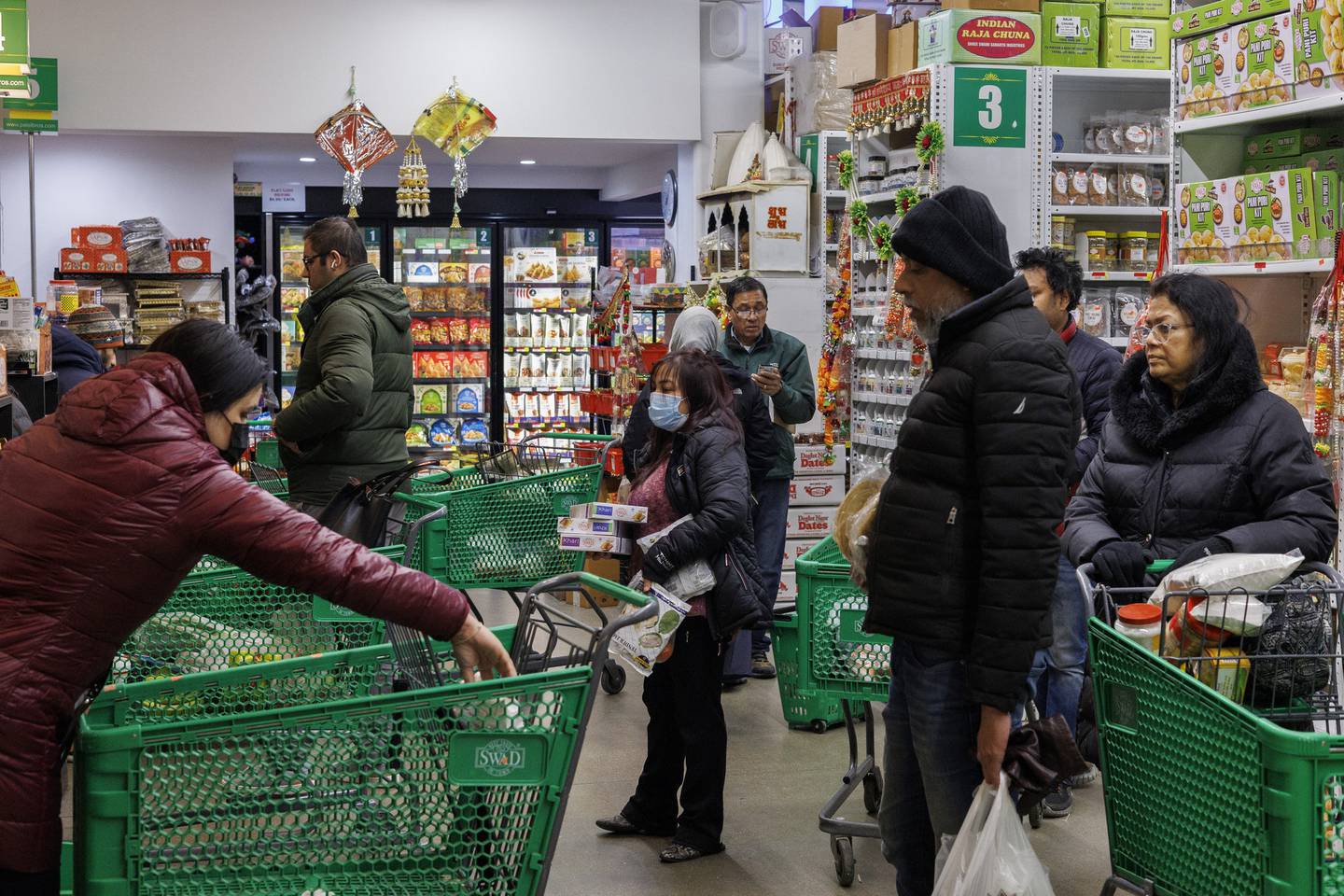 Shoppers wait to check out at Patel Brothers grocery store the day before a winter storm is expected to pass through the area on Dec. 21, 2022 in Chicago.