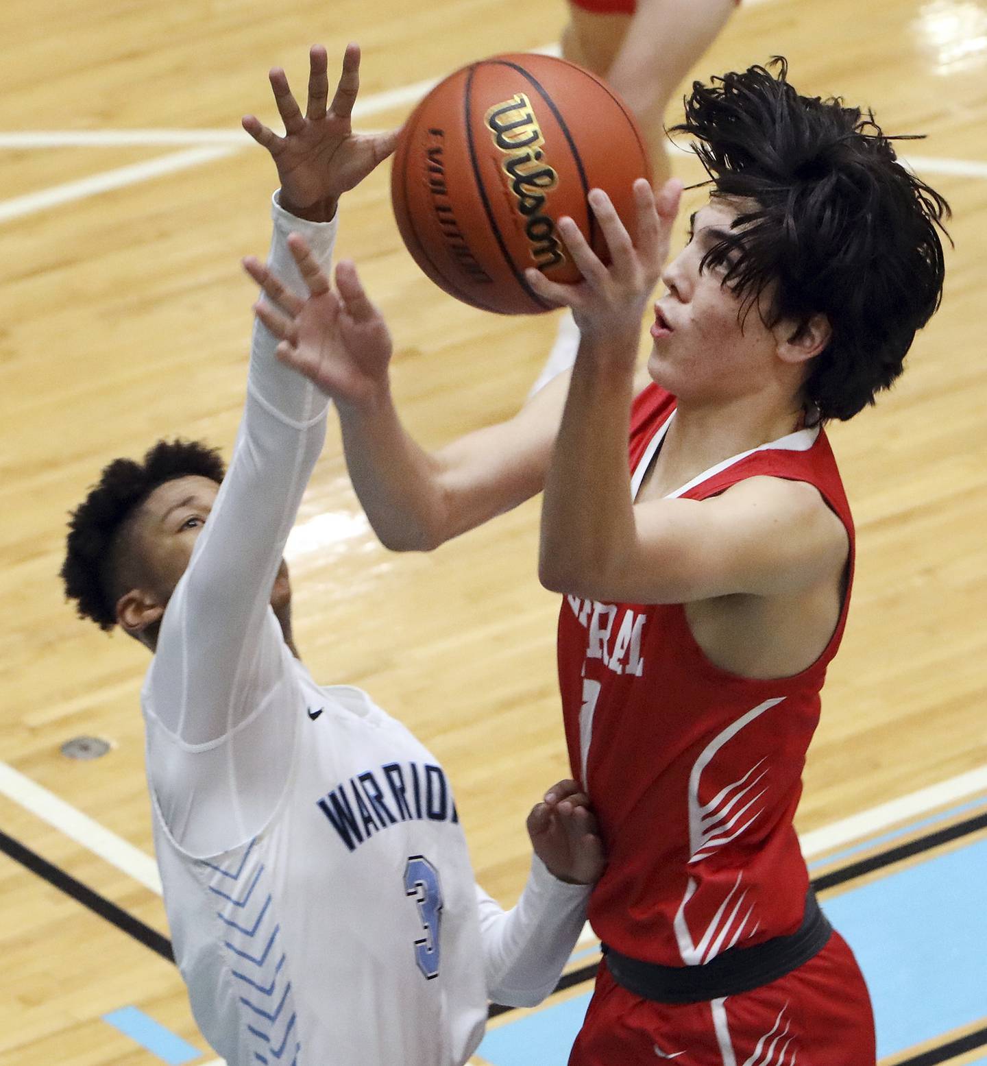 Naperville Central’s Grady Cooperkawa, right, puts up a shot against Willowbrook’s Tyler Royal during a game in Villa Park on Wednesday, Dec. 7, 2022. 