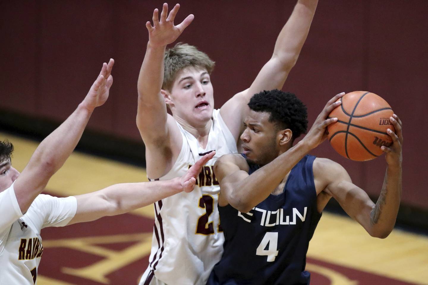 Evanston’s Prince Adams, right, gets double-teamed by Loyola’s Brendan Loftus, center, and Oliver Bishop during a game in Wilmette on Friday, Dec. 16, 2022.  