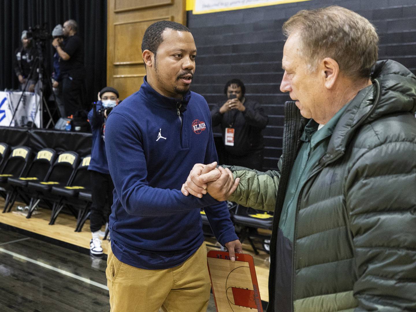 St. Rita coach Roshawn Russell, left, shakes hands with Michigan State coach Tom Izzo after a Catholic League crossover against St. Laurence in Burbank on Tuesday, Dec. 13, 2022.