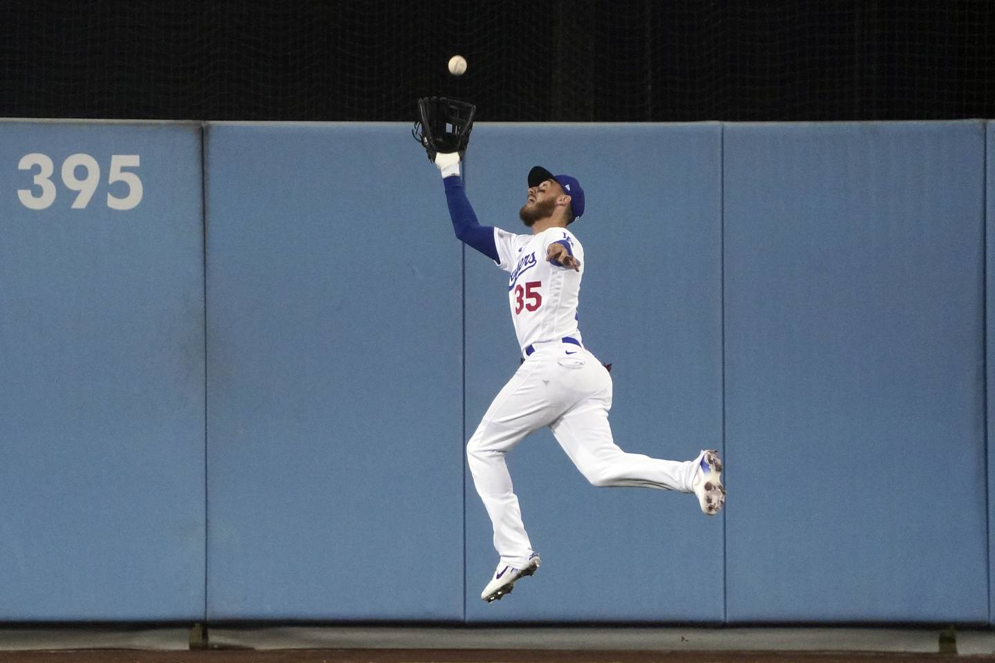 Dodgers center fielder Cody Bellinger makes a leaping catch on a line drive by the Padres' Austin Nola during the sixth inning on Oct. 12, 2022.