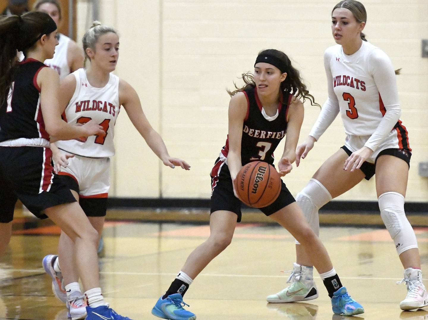 Deerfield’s Aubrey Galvan, second from right, tries to flip the ball to teammate Nikki Kerstein, left, as Libertyville’s Kate Rule, second from left, and Emily Fisher defend during a game in Libertyville on Saturday, Dec. 10, 2022. 