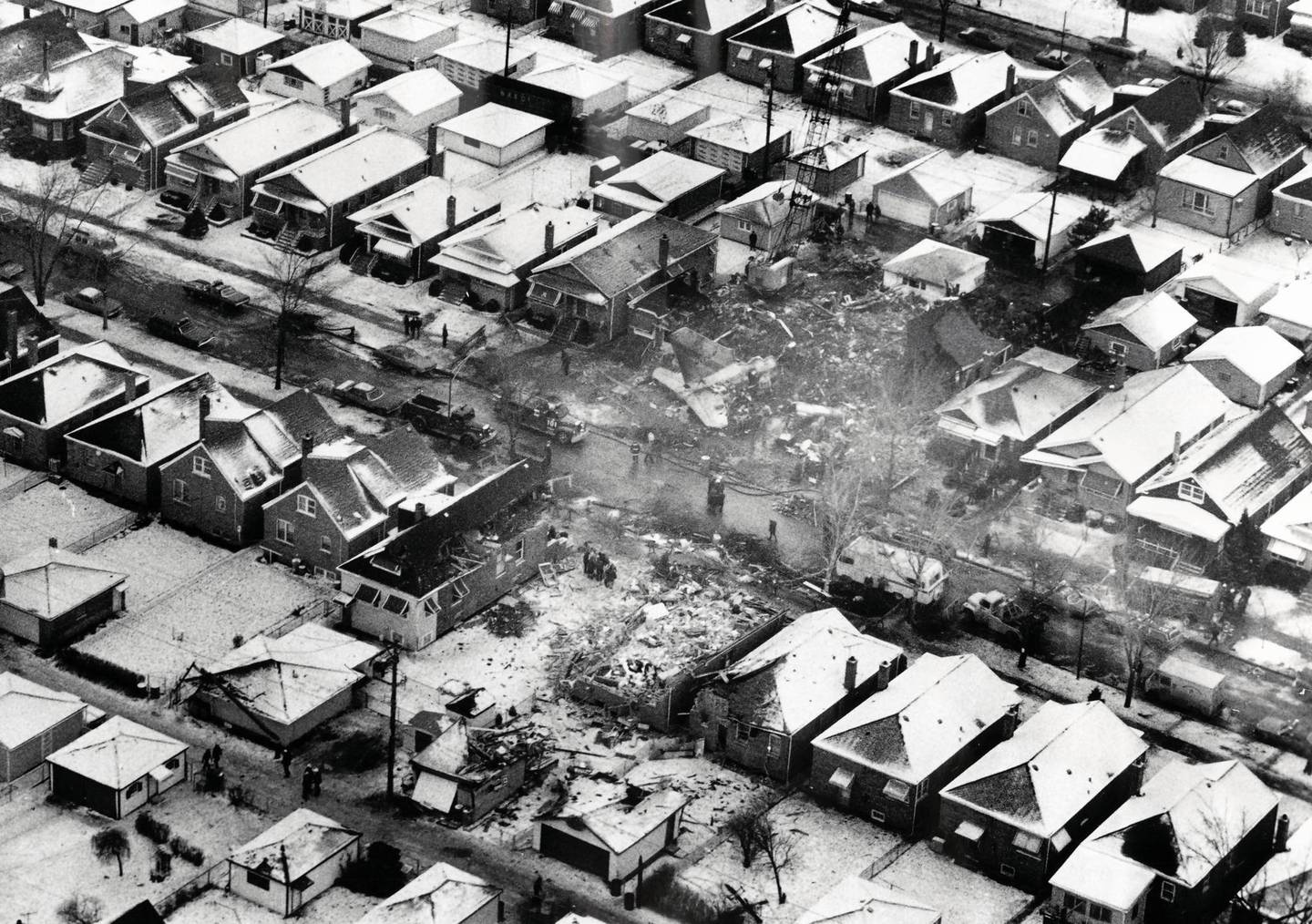 A photograph taken the day after the crash of United Airlines Flight 553 shows where the jetliner crashed into a row of bungalows on West 70th Place while approaching Midway Airport; 43 of the 61 persons aboard, and two in a home, were killed.