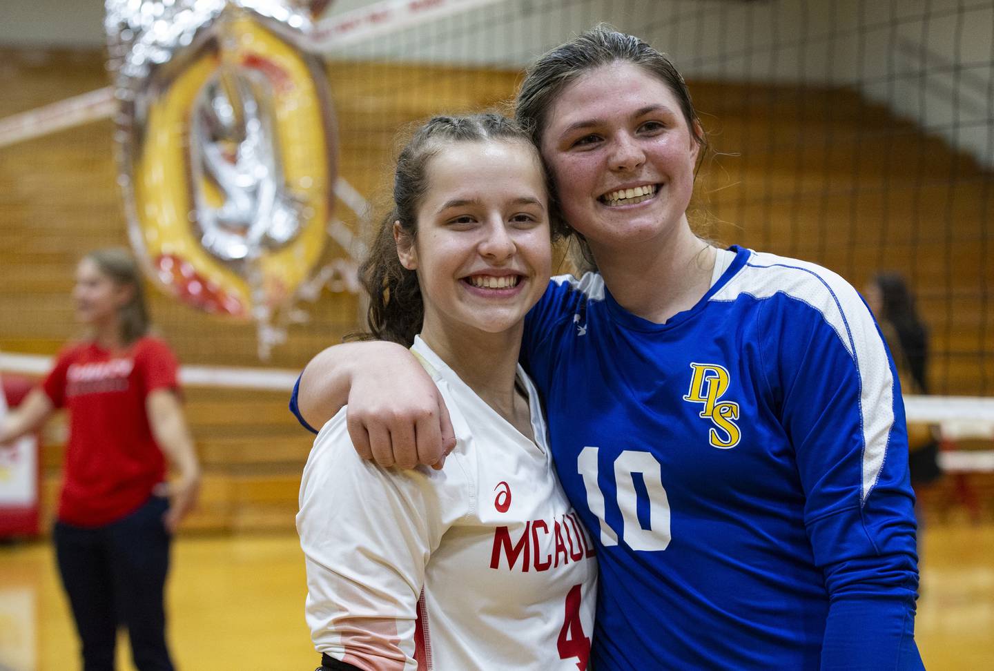 Mother McAuley's Sam Falk (4) and De La Salle's Jennifer Falk (10), who are cousins, hug after playing against each other in a GCAC Red match in Chicago on Tuesday, Oct. 11, 2022.