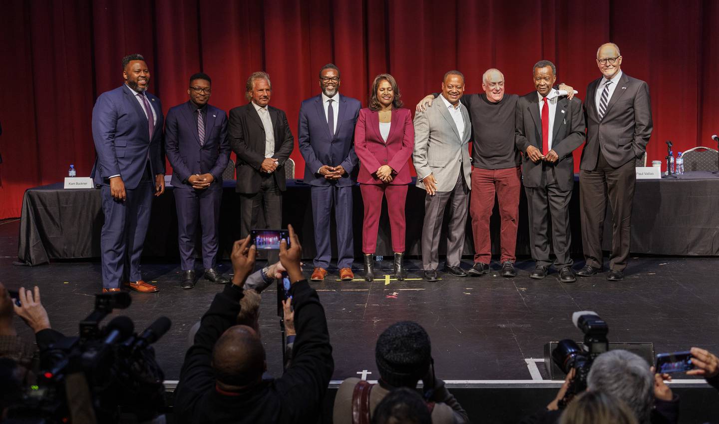 Chicago mayoral candidates, from left, state Rep. Kam Buckner; Ja’Mal Green; Johnny Logalbo; Cook County Commissioner Brandon Johnson; Ald. Sophia King, 4th; Ald. Roderick Sawyer, 6th; forum moderator Ben Joravsky; Willie Wilson; and Paul Vallas, pose for photographs at a forum hosted by the 38th Ward Democratic Organization at the Copernicus Center on Dec. 13, 2022.
