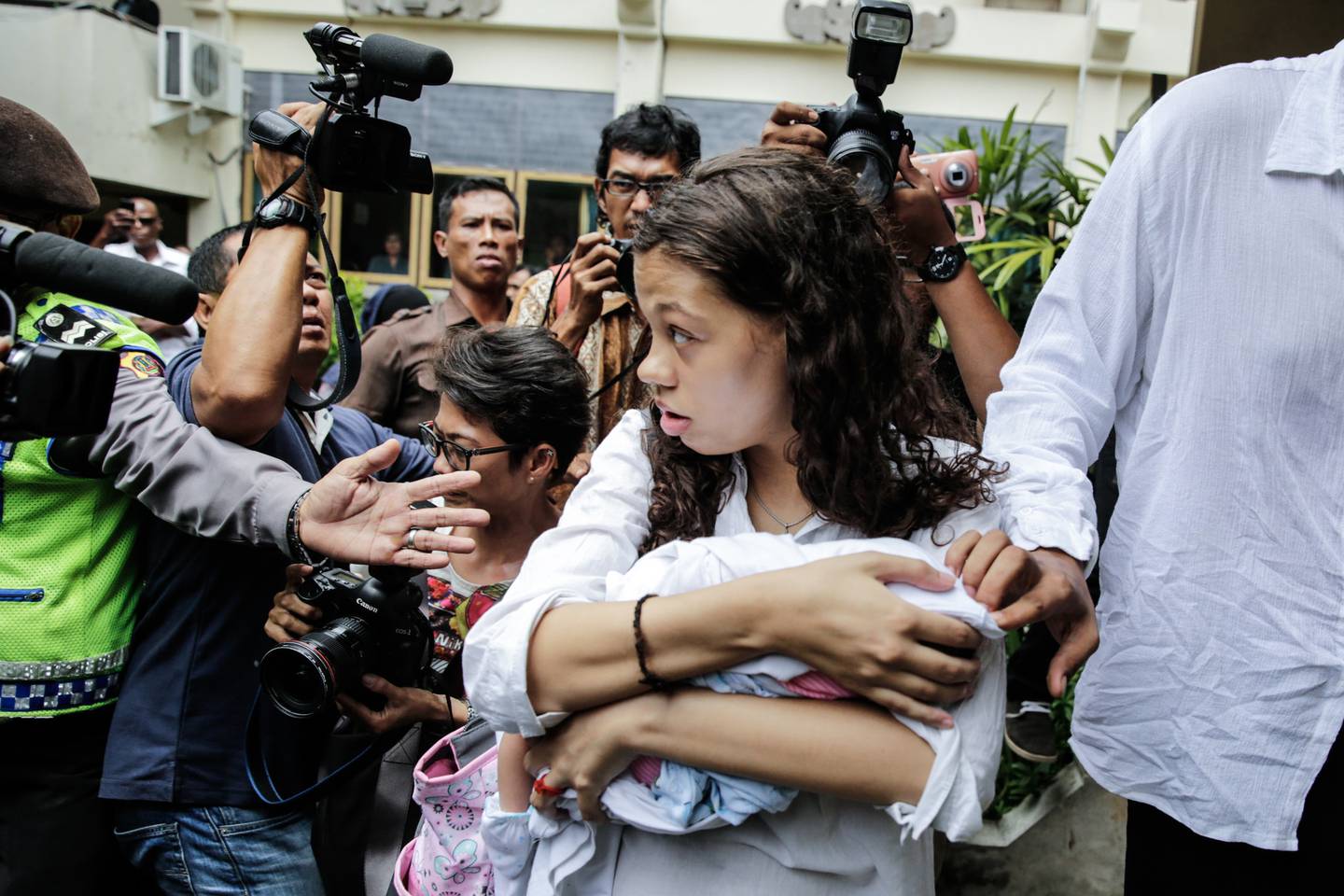 Heather Mack, 19, holds her baby as she and Tommy Schaefer arrived at court to attend their sentence demand trial on March 31, 2015 in Denpasar, Bali, Indonesia. Indonesian prosecutors asked a court to sentence Heather Mack to 15 years and Tommy Schaefer to 18 years in jail.