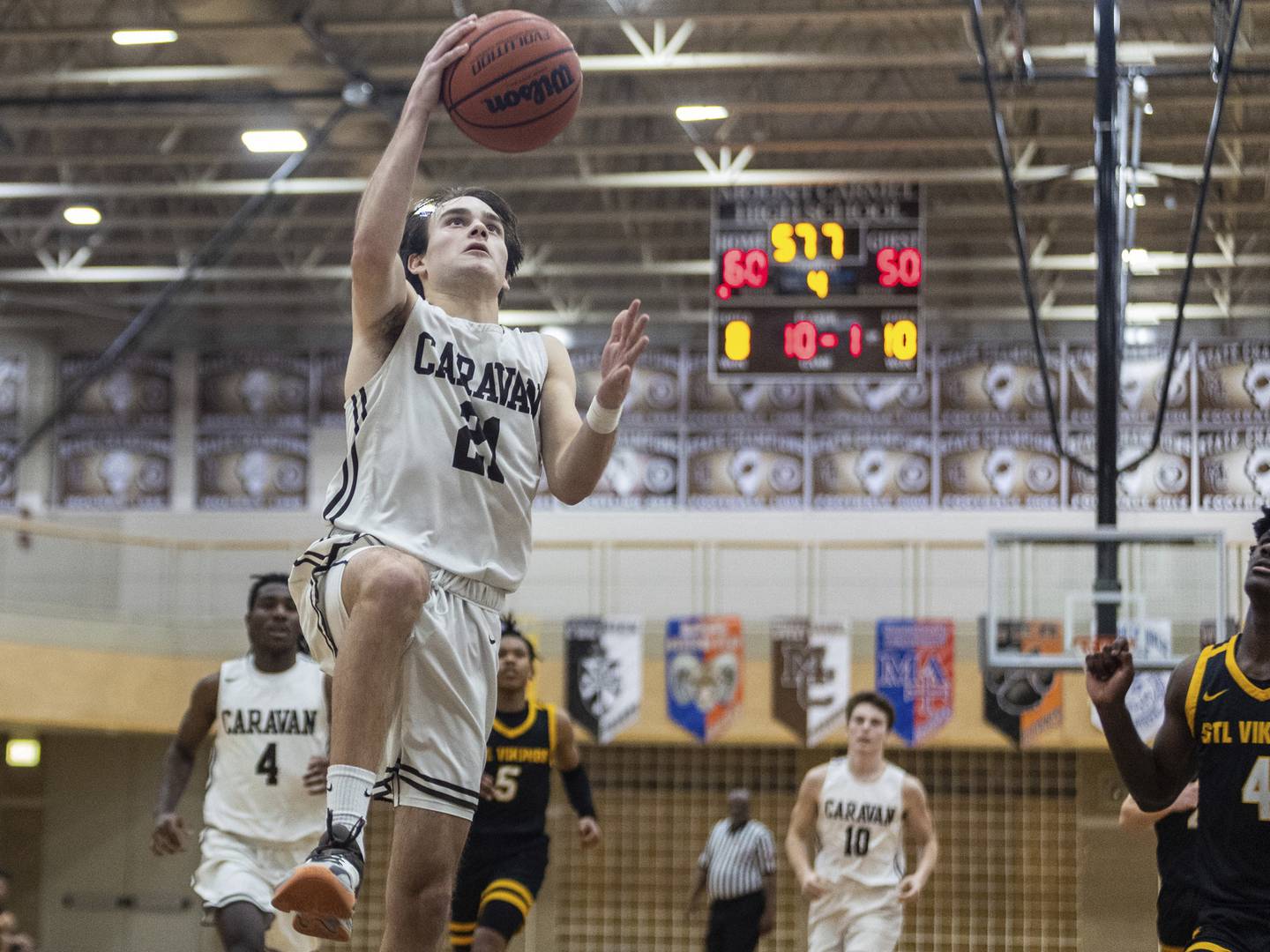 Mount Carmel's Anthony Ciaravino (21) finishes off a layup against St. Laurence during a Catholic League crossover in Chicago on Tuesday, Dec. 6, 2022.