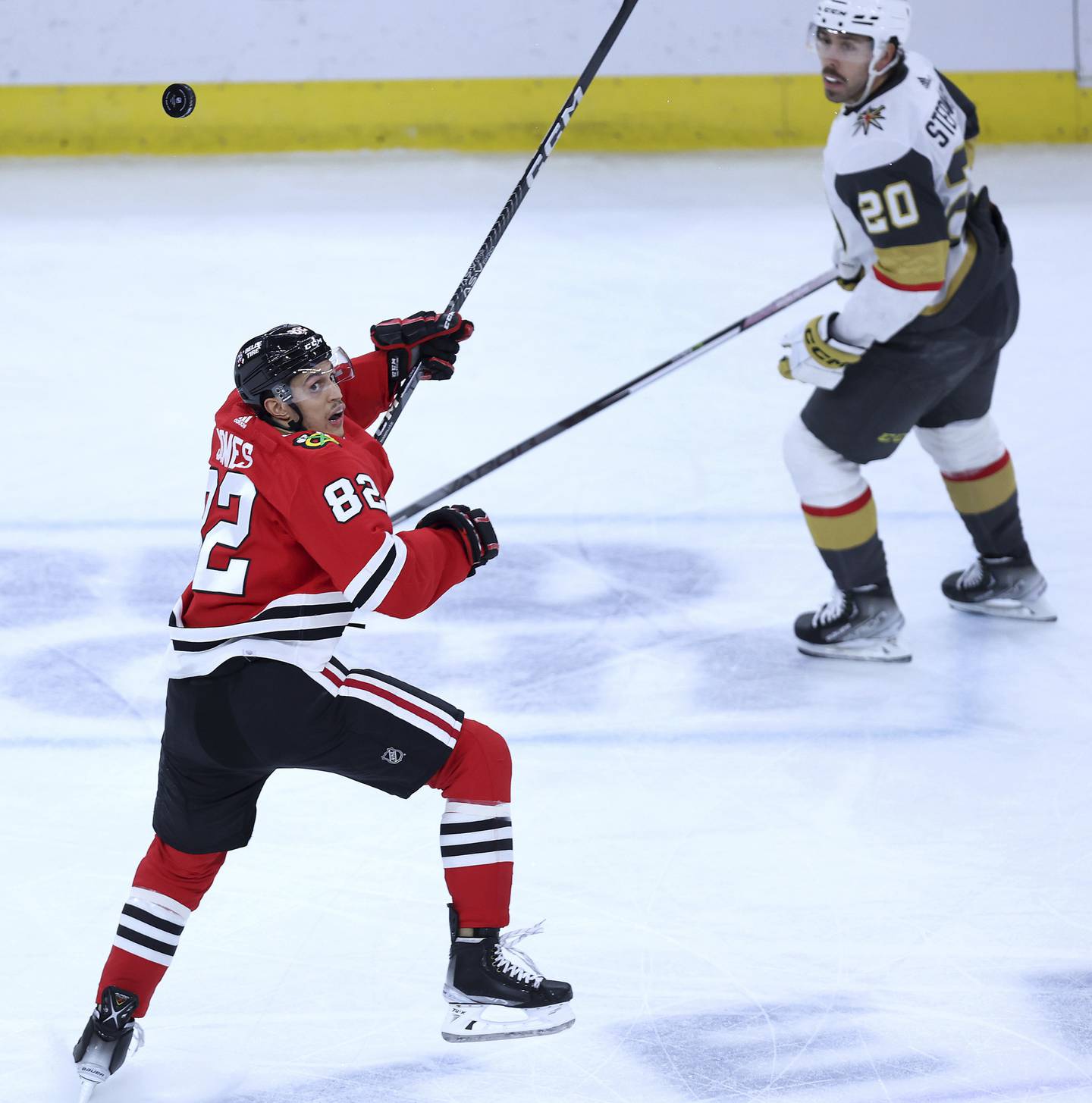 Blackhawks defenseman Caleb Jones keeps his eyes on an airborne puck in the second period against the Golden Knights at the United Center on Dec. 15, 2022.
