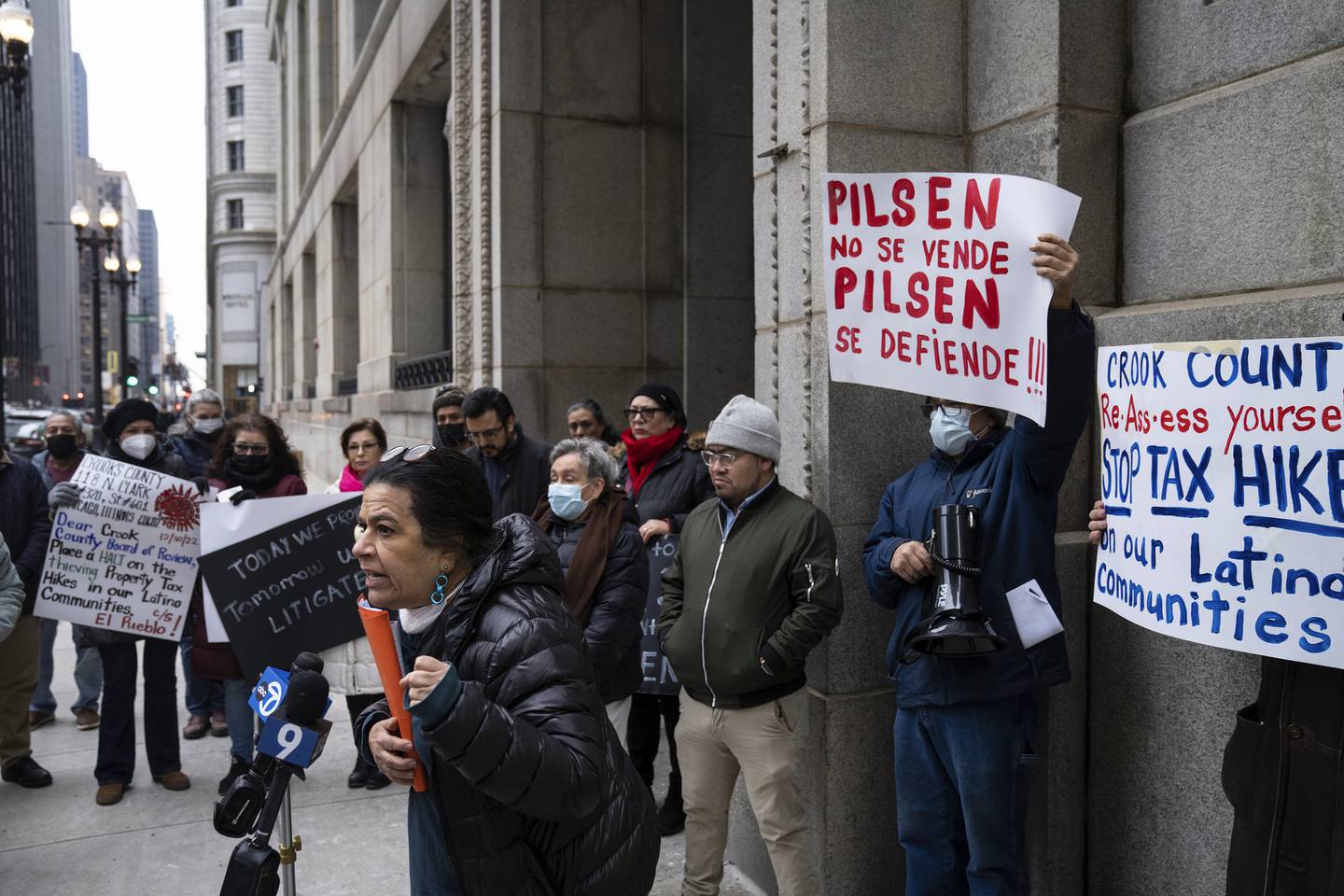 Organizer Laura Paz gathers with Pilsen residents and activists from a coalition of Pilsen community organizations for a rally at the Cook County Building to protest property tax increases on Dec. 30, 2022. 