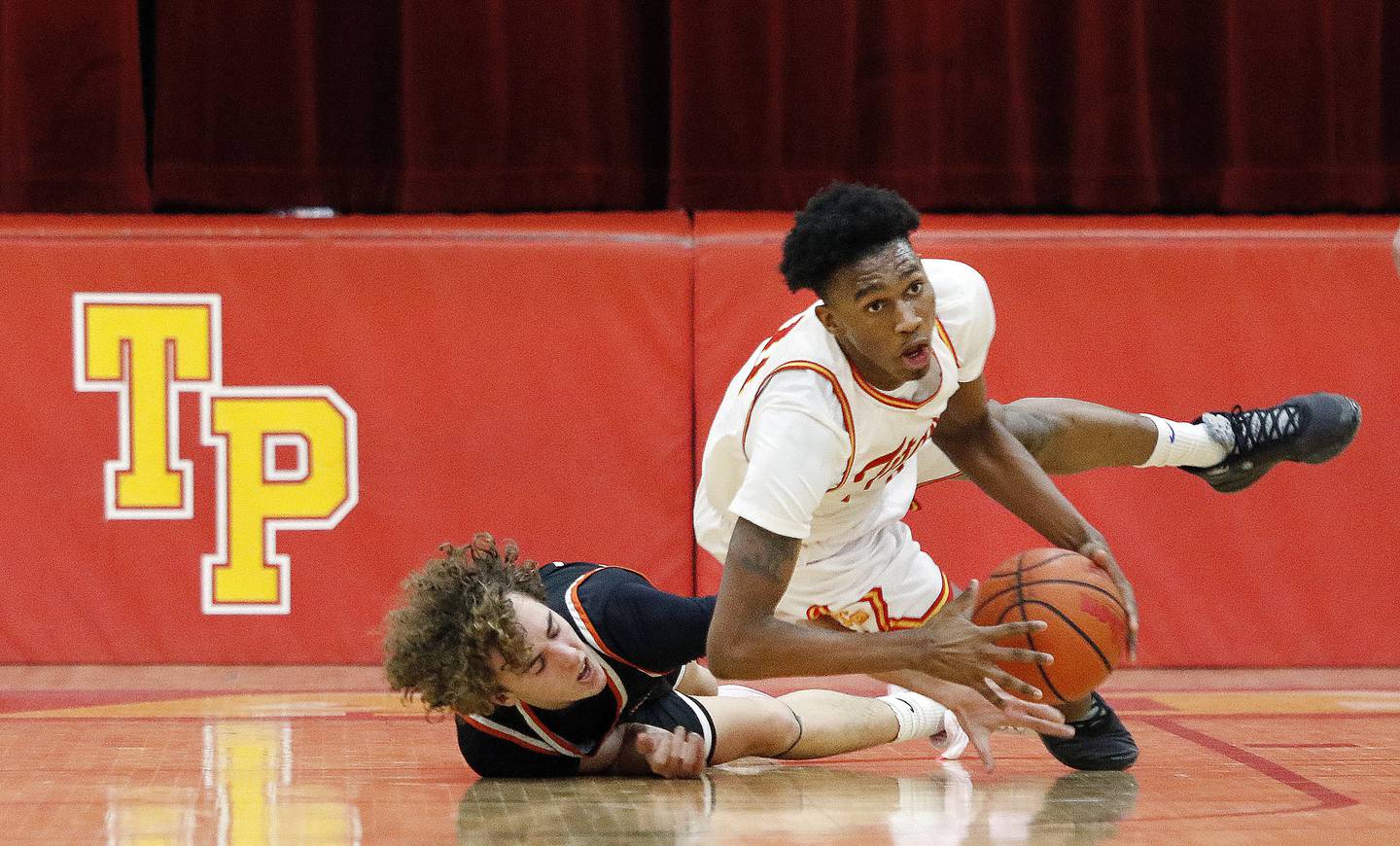 Lincoln-Way West's Jacob Bereza, left, and Tinley Park's Amarion Johnson hit the floor after a loose ball during a nonconference game on Monday Dec. 19, 2022.