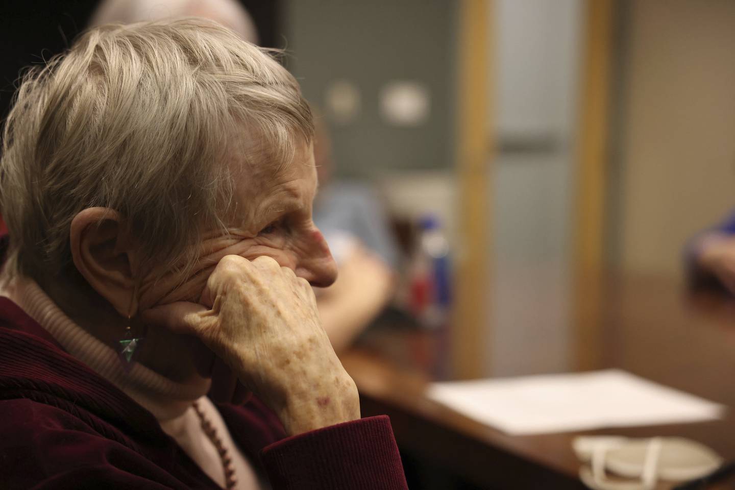Nora Natof, 87, listens to a conversation on death and dying with the End of Life Chicago company at the Oak Park library on Dec. 11, 2022. Natof spoke of her mother and grandparents dying and how ritual in the dying process was not encouraged at all.