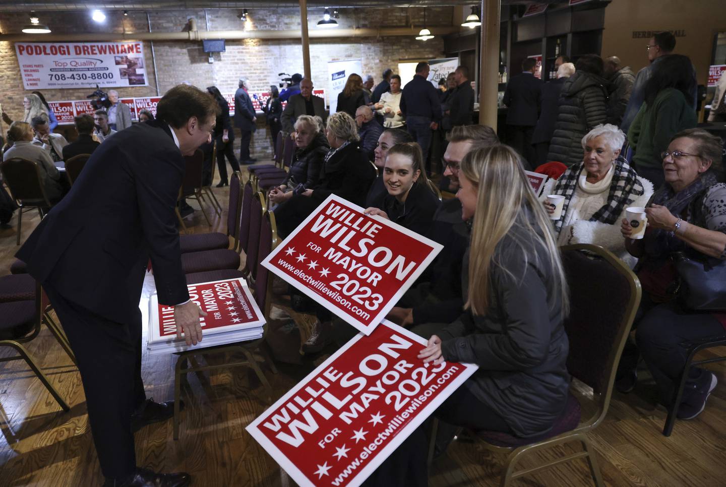 Signs are handed out prior to the arrival of Chicago mayoral candidate Willie Wilson at the Copernicus Center in Chicago’s Jefferson Park neighborhood on Nov. 15.  